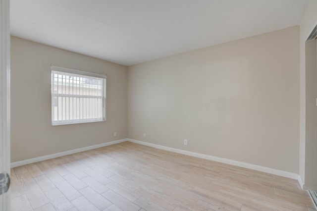 spare room featuring light hardwood / wood-style flooring