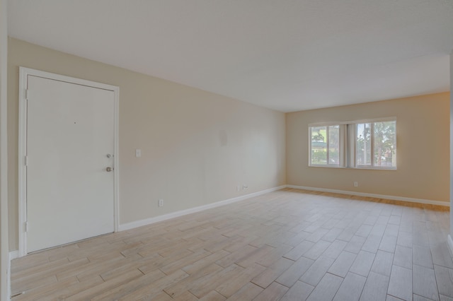 spare room with light hardwood / wood-style flooring