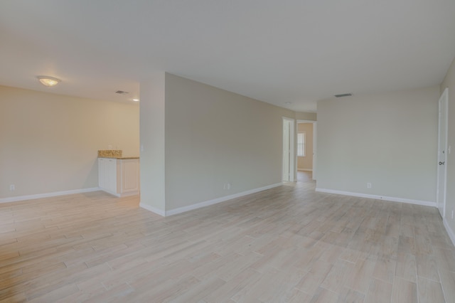 unfurnished room with light wood-type flooring