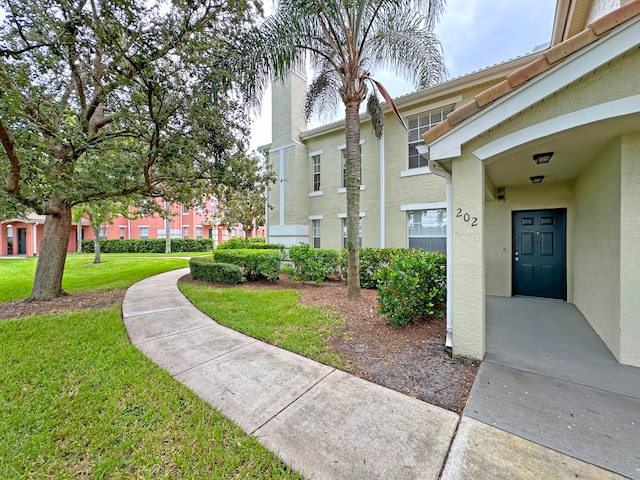 view of side of property with a lawn