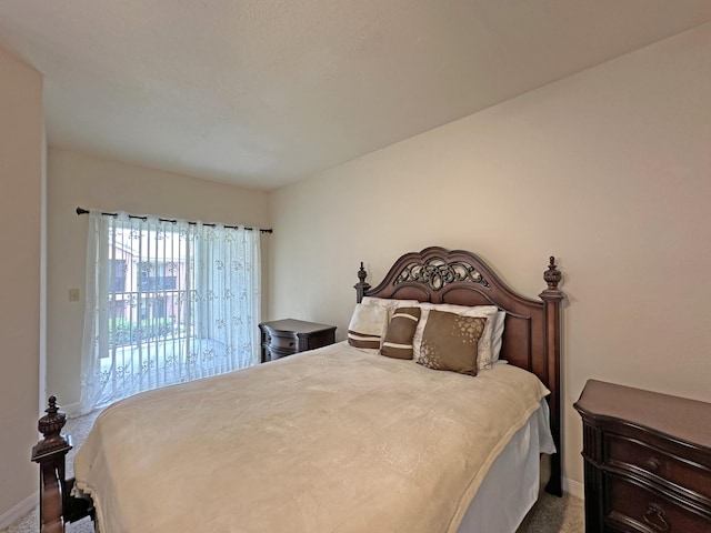 carpeted bedroom featuring access to exterior and baseboards