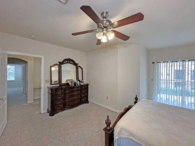 bedroom featuring ceiling fan and light carpet