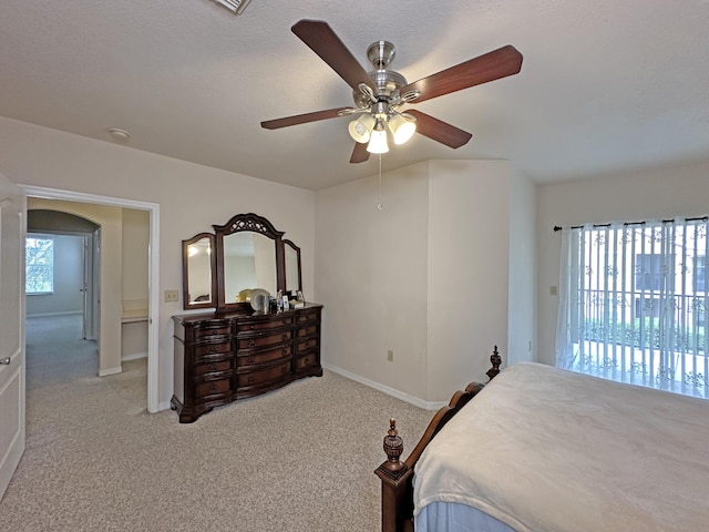 bedroom with baseboards, arched walkways, ceiling fan, access to exterior, and light colored carpet