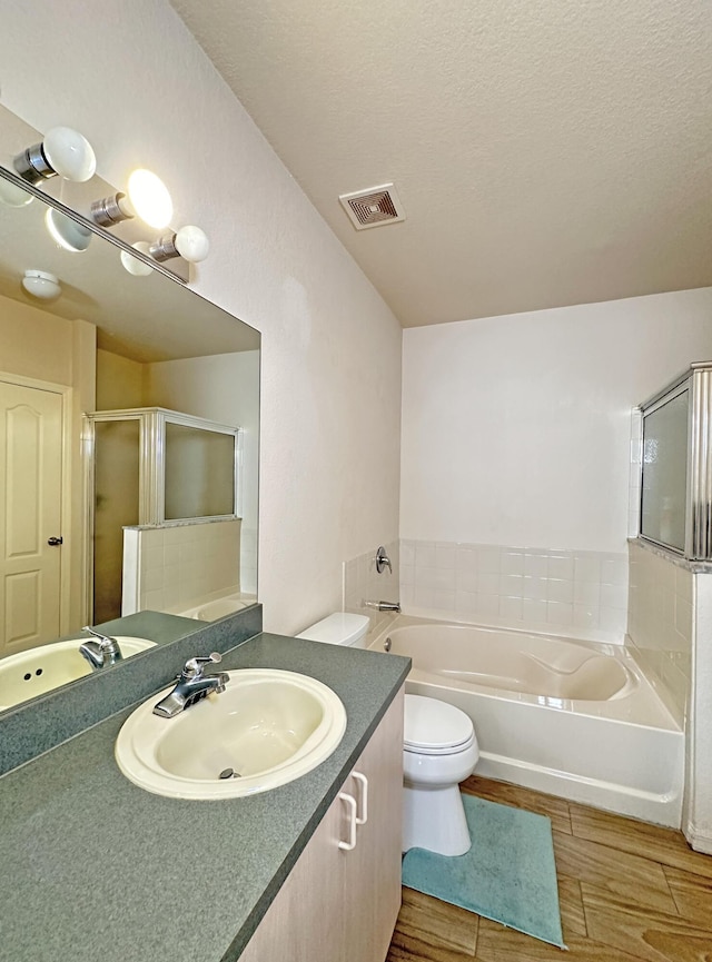 full bathroom featuring visible vents, a garden tub, toilet, a stall shower, and vanity