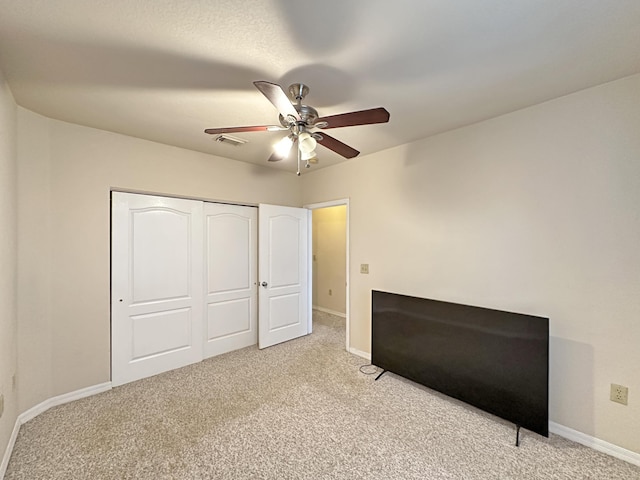 unfurnished bedroom with carpet flooring, baseboards, visible vents, and a closet