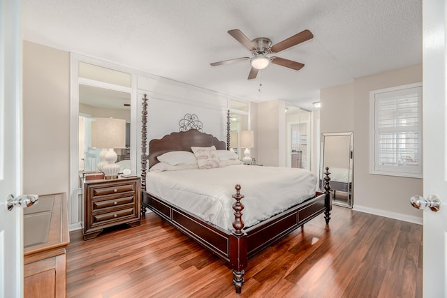 bedroom featuring ceiling fan, dark hardwood / wood-style flooring, and a textured ceiling