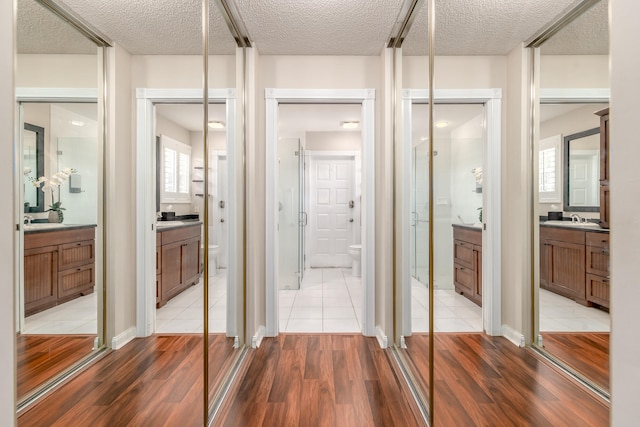 bathroom featuring hardwood / wood-style floors, toilet, a textured ceiling, and vanity