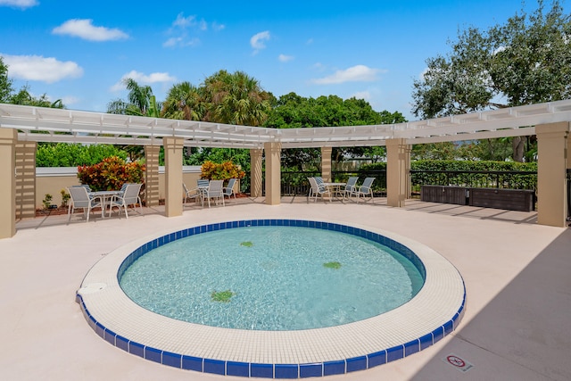 view of swimming pool featuring a pergola and a patio area