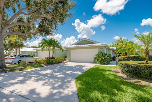 view of front of house featuring a garage and a front yard