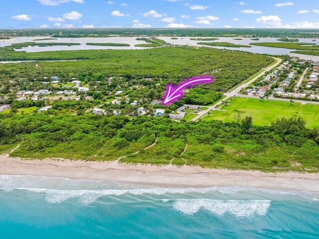 bird's eye view featuring a beach view and a water view