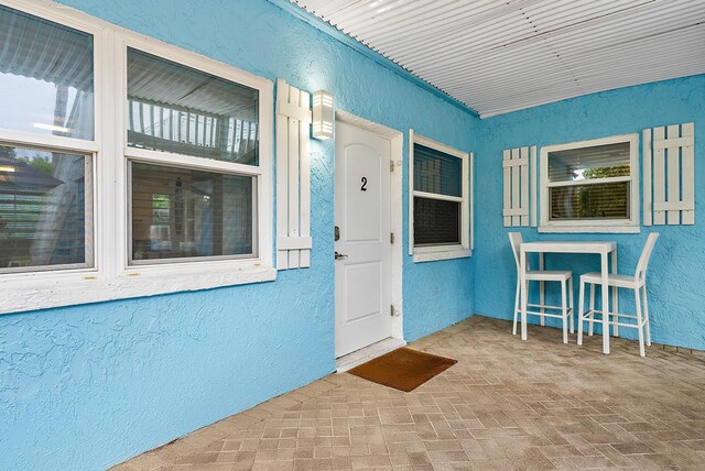 entrance to property featuring stucco siding