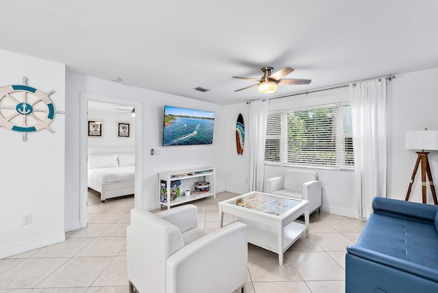 living room with ceiling fan, visible vents, and light tile patterned flooring