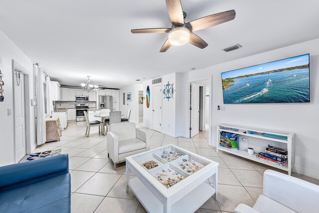 kitchen with a kitchen bar, light stone counters, white cabinets, and light tile patterned flooring