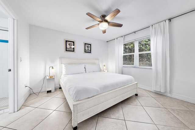 bedroom featuring ceiling fan, light tile patterned flooring, and baseboards