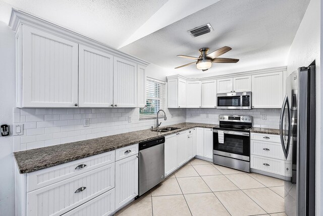 kitchen featuring appliances with stainless steel finishes, visible vents, a sink, and white cabinetry