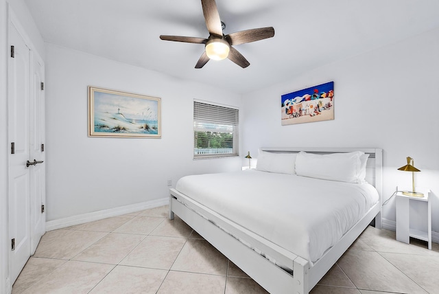 bedroom featuring light tile patterned flooring, ceiling fan, and baseboards