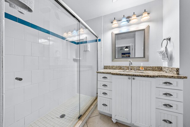 bathroom with a shower stall, vanity, and tile patterned floors