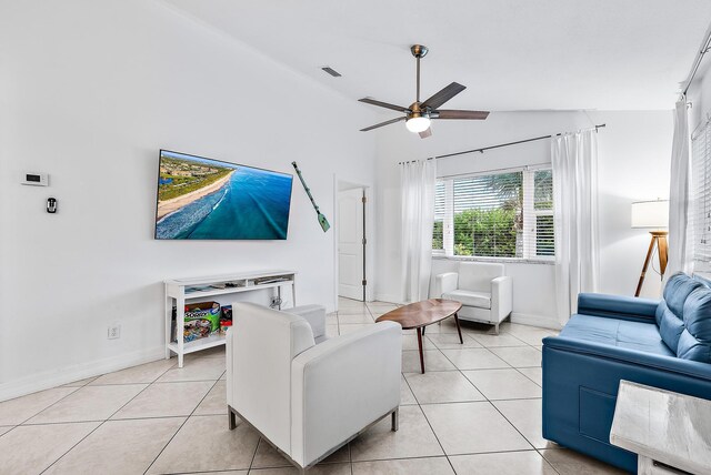 kitchen with a center island, vaulted ceiling, appliances with stainless steel finishes, light tile patterned flooring, and decorative backsplash