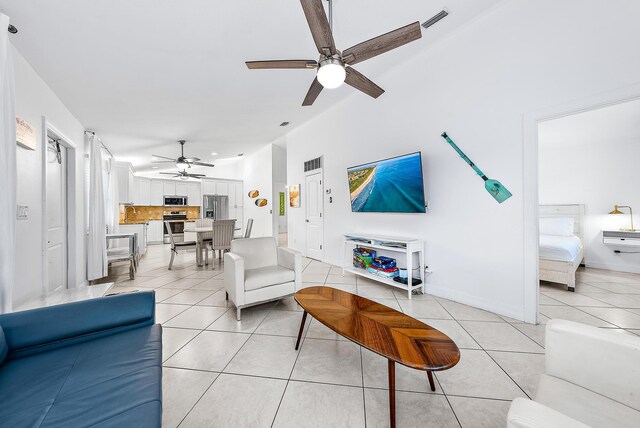 kitchen featuring white cabinets, vaulted ceiling, a breakfast bar area, and ceiling fan