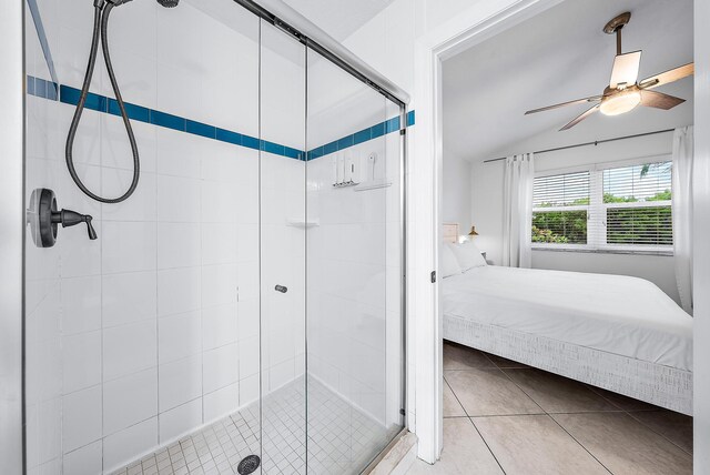 ensuite bathroom with a stall shower, ceiling fan, ensuite bath, and tile patterned floors