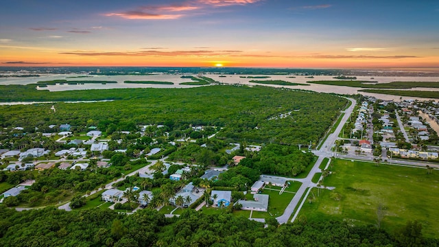 aerial view at dusk with a water view