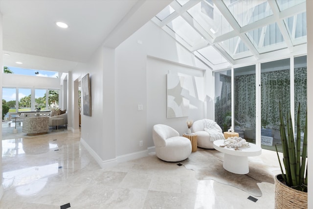 sitting room featuring lofted ceiling