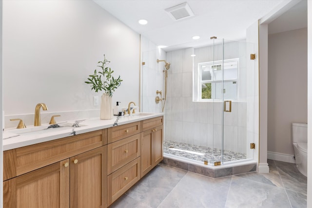 bathroom with a shower with shower door, vanity, and toilet