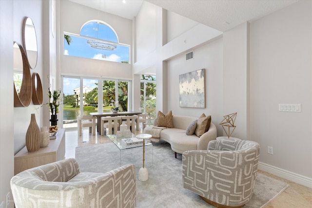 interior space featuring a towering ceiling and light tile patterned floors