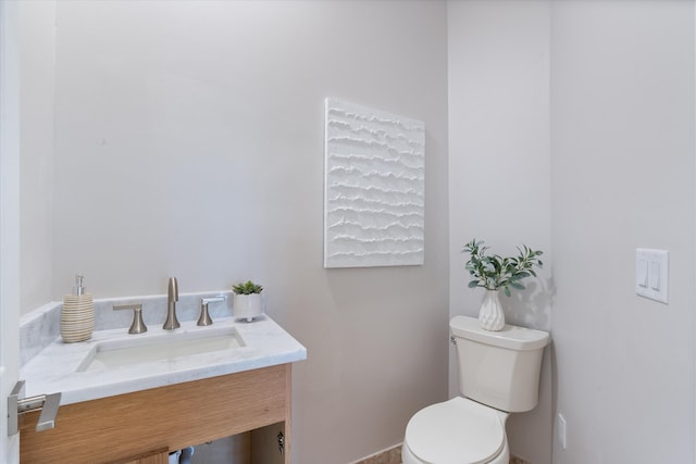 bathroom with toilet and vanity