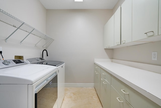 laundry area featuring cabinets and independent washer and dryer