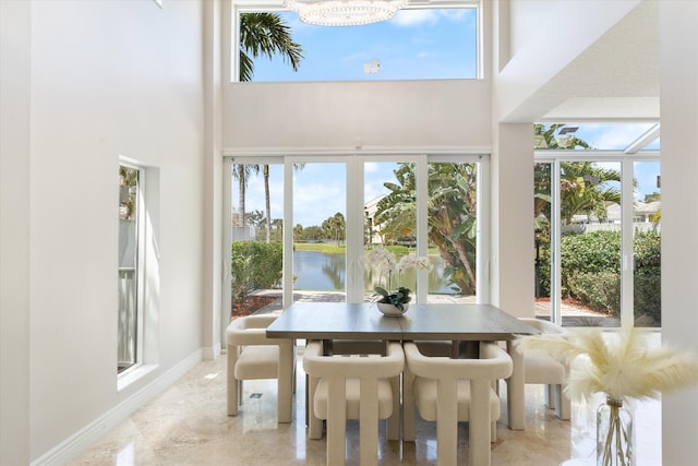 sunroom / solarium featuring a wealth of natural light and a water view