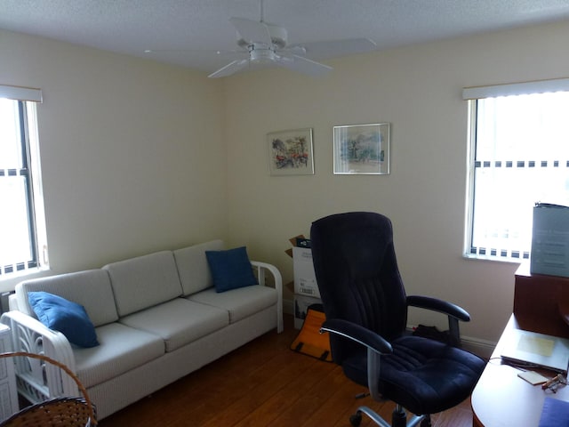 office space with a ceiling fan and wood finished floors