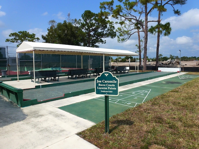 surrounding community with fence and shuffleboard