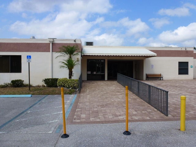 view of building exterior with uncovered parking