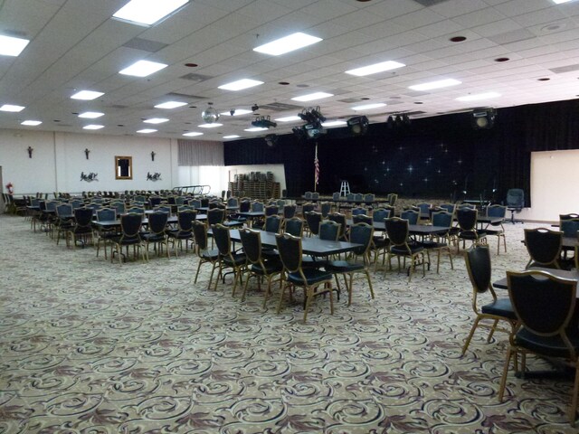 carpeted dining room featuring a paneled ceiling