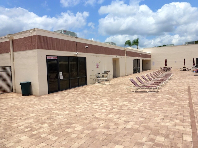 rear view of property with a patio and stucco siding