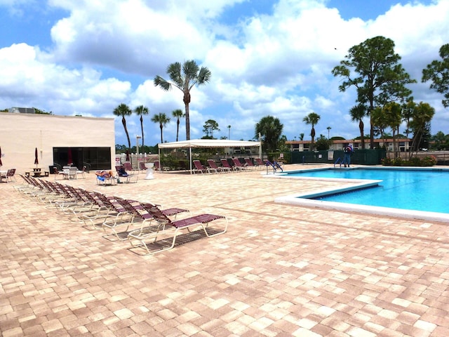 pool featuring fence and a patio