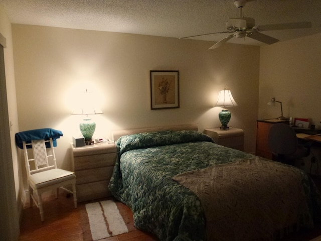 bedroom featuring a textured ceiling, ceiling fan, and hardwood / wood-style flooring