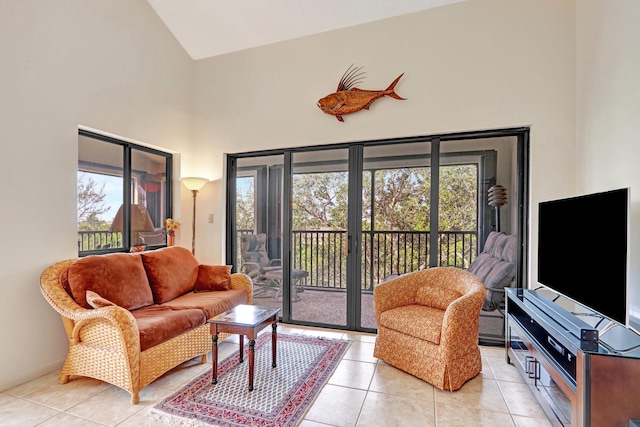 tiled living room with plenty of natural light and high vaulted ceiling