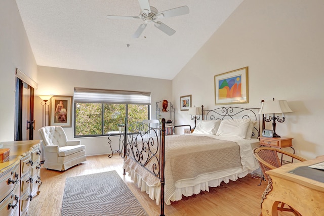 bedroom with ceiling fan, light hardwood / wood-style floors, and high vaulted ceiling