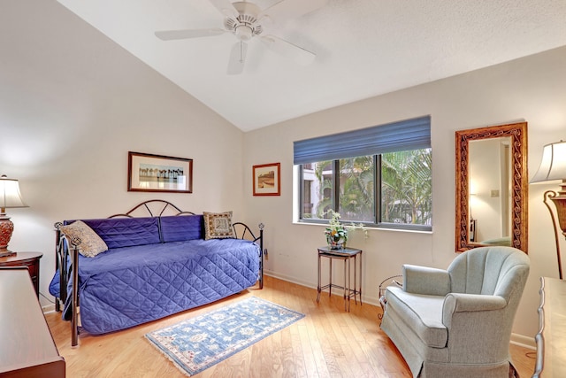 bedroom featuring lofted ceiling, ceiling fan, and light hardwood / wood-style flooring