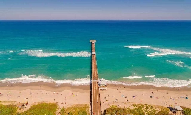 birds eye view of property featuring a beach view and a water view