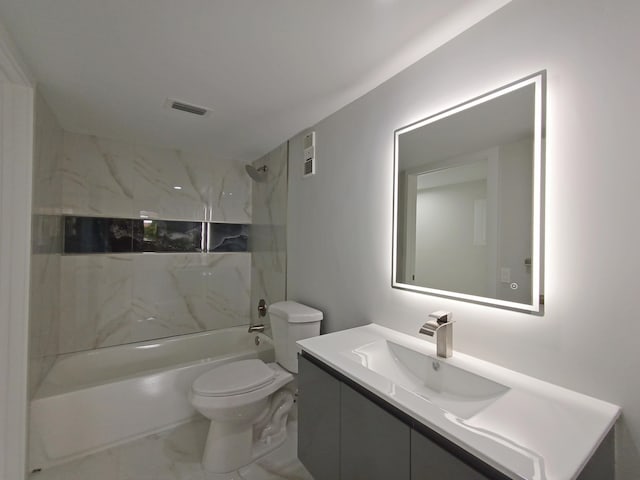 full bathroom featuring vanity, tiled shower / bath combo, and toilet