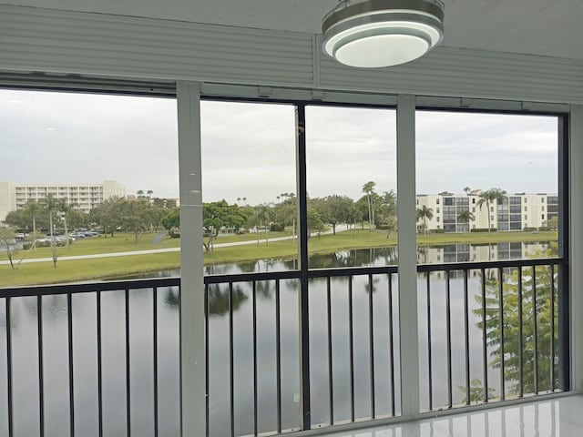 unfurnished sunroom with a water view and a wealth of natural light