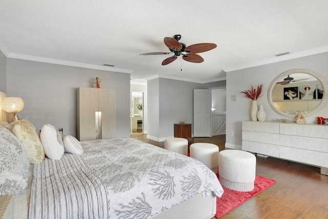 bedroom featuring ornamental molding, ceiling fan, dark hardwood / wood-style floors, and a textured ceiling