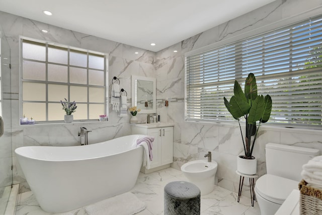 bathroom featuring a tub, tile walls, toilet, and a healthy amount of sunlight