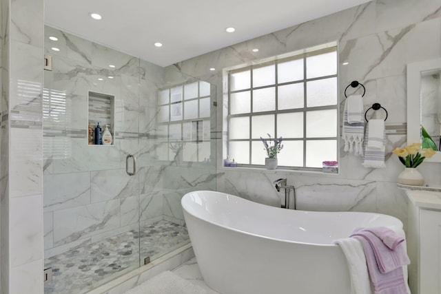 bathroom with plus walk in shower and tile walls