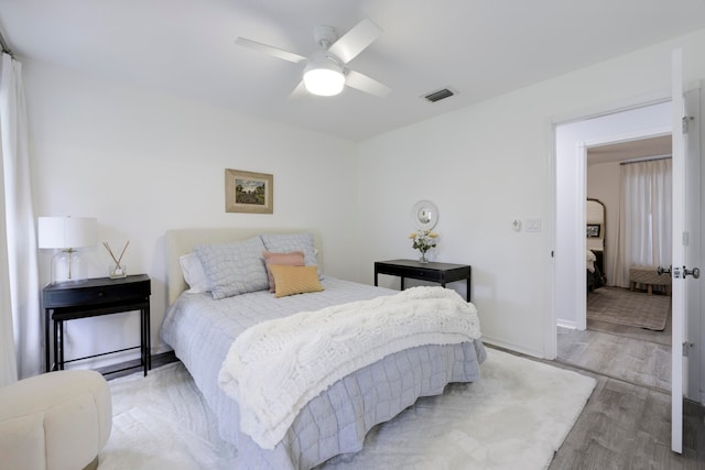 bedroom featuring light wood-type flooring and ceiling fan