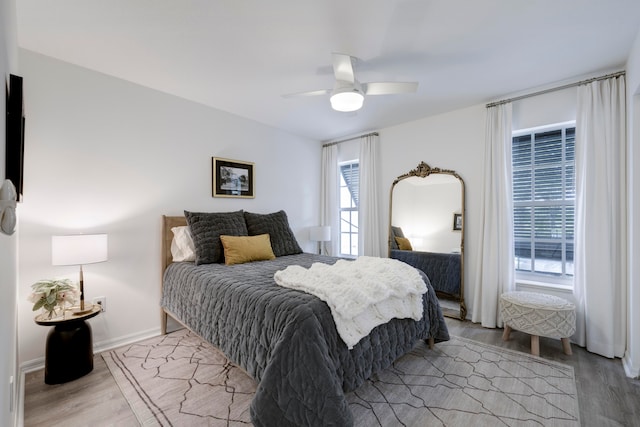 bedroom with light hardwood / wood-style flooring and ceiling fan