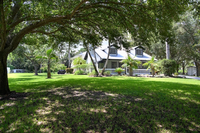 view of yard featuring a storage shed and covered porch